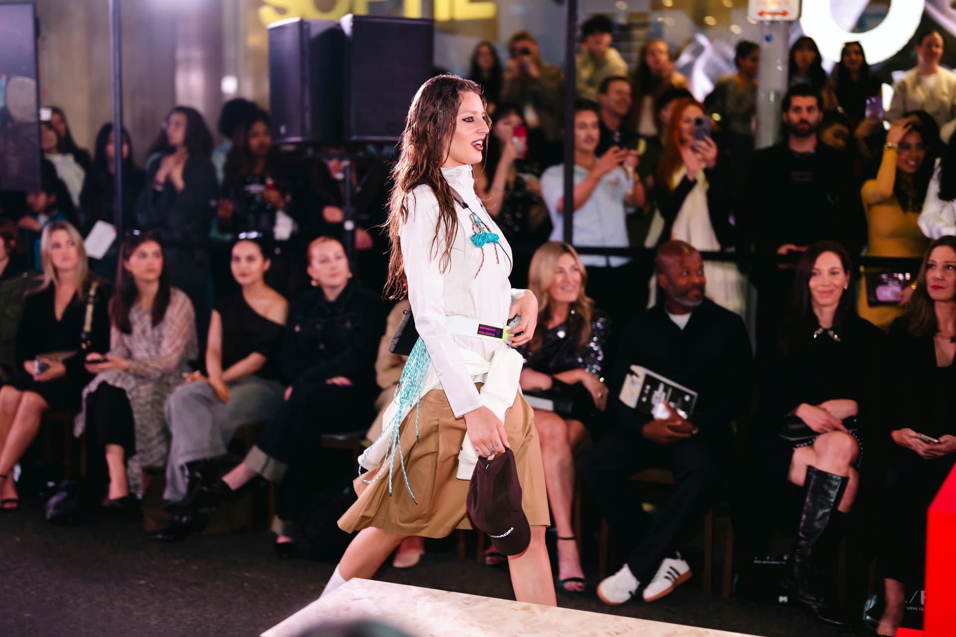 Guests gather around a fashion presentation space during an independent event