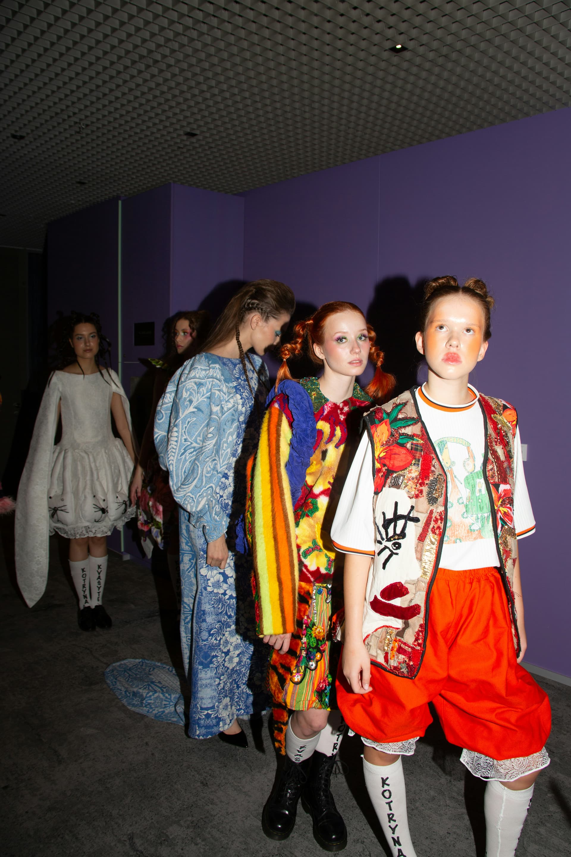 A designer presentation layout with garments displayed for close viewing